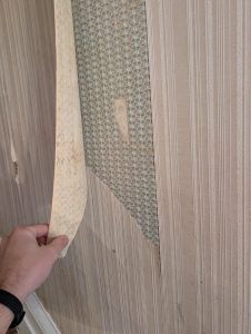 Multiple layers of wallpaper uncovered during removal in old farmhouse