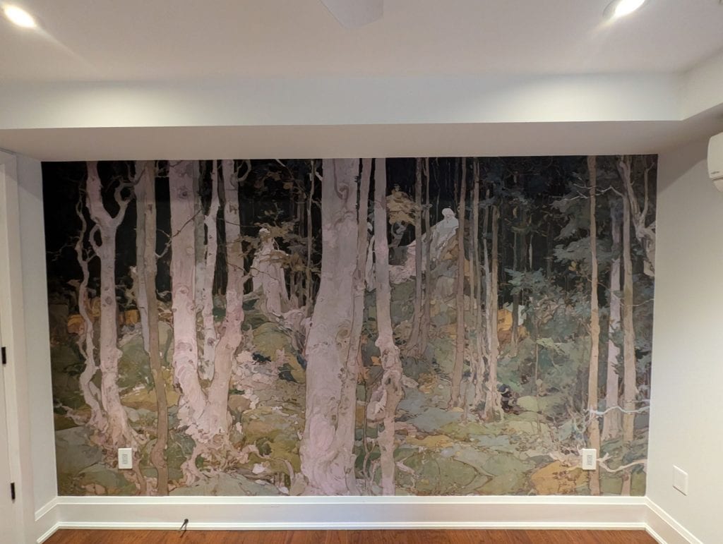 Custom forest mural wallpaper installed as a feature wall in a Hamilton home, showcasing a woodland scene with trees, natural tones, and artistic landscape details. Professional wallpaper installation by DW Painting & Wallpapering.