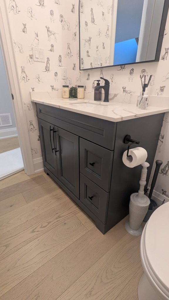 Bathroom vanity refinished in a modern dark finish as an alternative to cabinet replacement.
