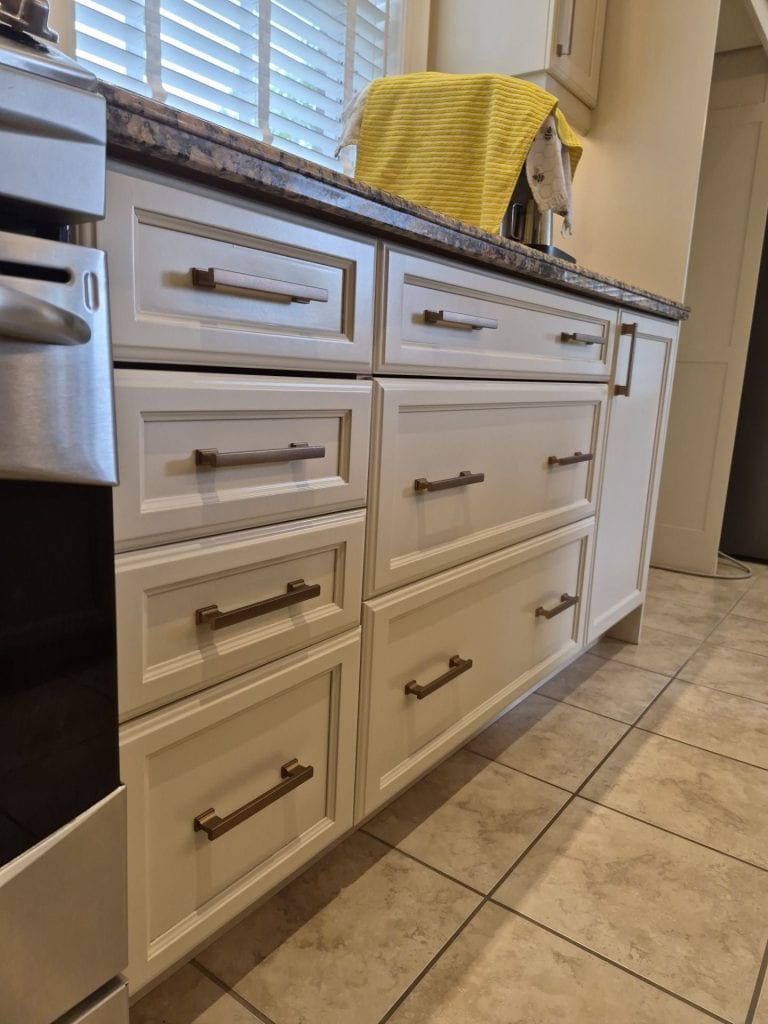 Close-up of new cabinet hardware installed during a professional kitchen cabinet refinishing project in Ancaster.
