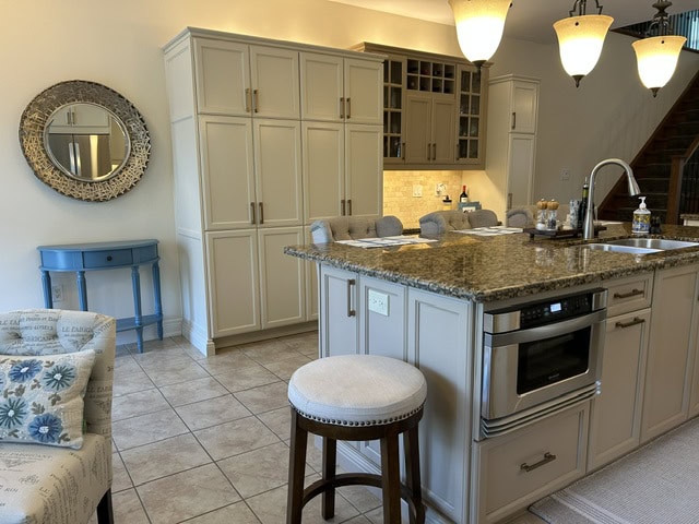 Professionally refinished kitchen cabinets and island completed during an Ancaster cabinet refinishing project.