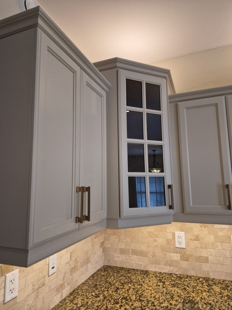 Close-up of professionally refinished kitchen cabinets featuring premium cabinet coatings and a smooth factory-like finish in Ancaster, Ontario.
